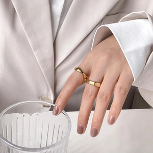 Golden bamboo joint stackable rings with irregular wave design worn by female model