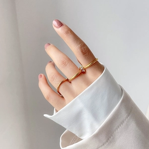 Nahaufnahme des minimalistischen goldenen Dreifingerrings mit geometrischem Steg-Design