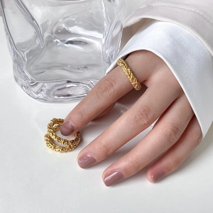 Macro detail of gold-plated double-layer rings with unique crater-like lava textures