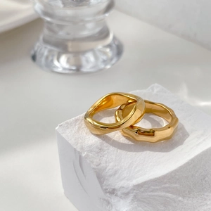 Detailed view of gold bamboo texture and irregular geometric rings on stone display