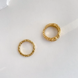 Detail of gold double-layer crater rings with unique hammered texture and vintage finish