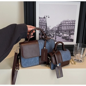 Detailed view of the brown leather and denim patchwork handbag set with chain strap