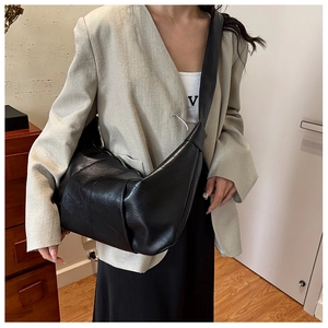 Detailed view of the black large hobo bag with soft leather texture and wide shoulder strap