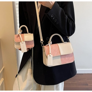 Detail of pink glitter and cream leather crossbody bag set with chain strap