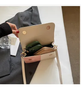 Detailed interior of minimalist bicolor crossbody bag with magnetic clasp and phone pocket