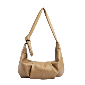 Minimalist soft leather crescent hobo bag in camel with pleated details and knotted strap