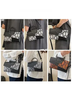 Detail of snake skin pattern handbag with metal ring handle and adjustable strap