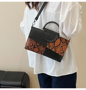 Lifestyle shot of snake print crossbody bag with litchi grain texture for women