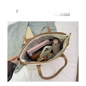 Spacious tote bag interior showing storage for tablet, books, and daily essentials