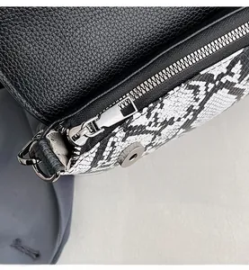 Detailed macro view of smooth silver zipper and textured snake pattern leather panel