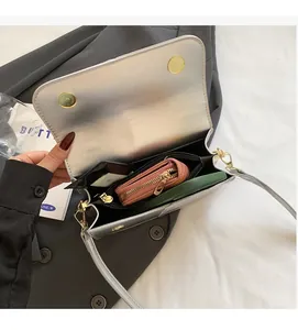 Interior view of silver mirror bag showing spacious compartments and magnetic closure