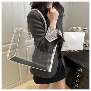 Detailed view of transparent PVC tote bag with white PU trim and rope handle