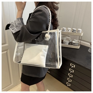 Detail view of transparent PVC tote bag with woven rope handle and tassel knot decoration