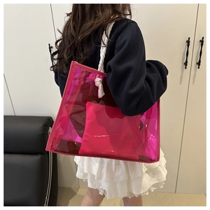 Detail of rose red transparent tote bag featuring woven rope handles and inner pouch