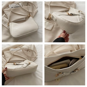 Detailed views of beige crocodile embossed hobo bag with gold hardware and interior pocket