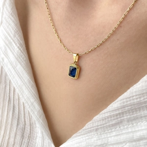 Elegant gold paperclip chain necklace featuring a rectangular navy blue gemstone pendant