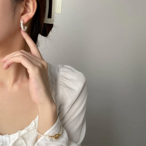 Elegant white pearl C-shaped earrings and matching bracelet set with gold T-bar clasp