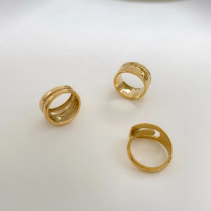 Three gold irregular rings with smooth metallic finish and layered hollow design