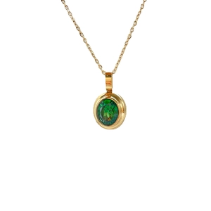 Elegant gold necklace featuring an oval emerald green gemstone pendant with faceted cut