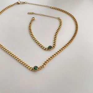 Detail of 18KGP gold necklace and bracelet set with green emerald cubic zirconia