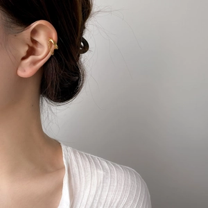 Detail of 18K gold plated ear cuff featuring a delicate metal tassel chain