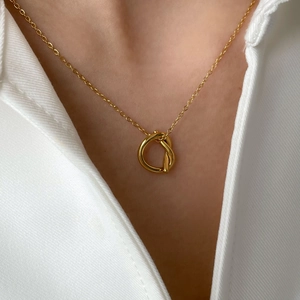 Vintage irregular golden knot pendant necklace with fine link chain on female model