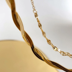 Elegant gold double-layer snake bone chain necklace in minimalist titanium steel design