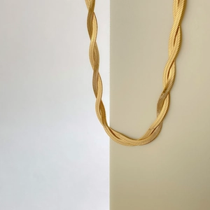 Close-up of golden multi-layer twisted herringbone chain necklace in 18K gold plated steel