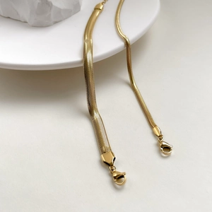 Elegant gold flat snake chain bracelet in titanium steel with a secure lobster clasp