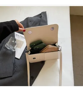 Interior view of off-white crossbody bag showing ample space for phone and wallet