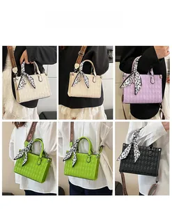 Detail view of quilted tote bags in four colors with floral scarves and wide straps