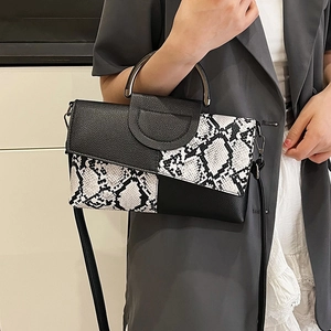 Chic snakeskin print handbag with metal handles and adjustable crossbody strap