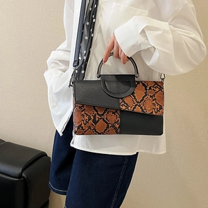 Elegant snake print patchwork handbag with metal handle and shoulder strap for women