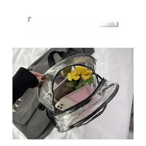 Detail of transparent PVC backpack showing spacious interior with books and tulips