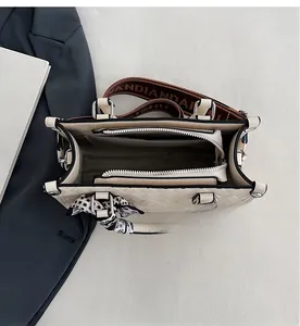 Internal view of beige quilted tote bag showing multiple compartments and spacious storage