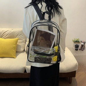 Waterproof clear PVC backpack with black straps shown in a cozy lifestyle setting