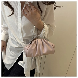 Detail of light pink pleated cloud bag with pearl handle and vintage silver metal clasp