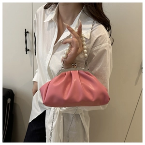 Detail of pink pleated cloud bag with large pearl handle and silver metal chain strap
