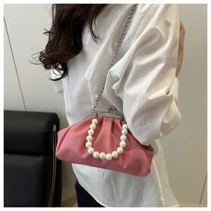 Detail of pink pleated cloud bag with pearl handle and silver chain strap
