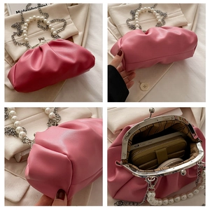 Internal view of pink cloud bag showing storage space for phone and makeup accessories