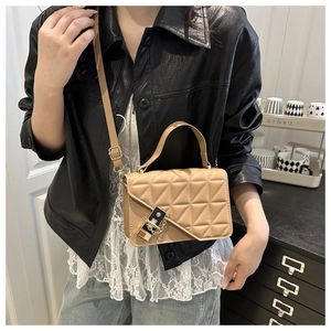 Detail of khaki leather crossbody bag with geometric stitching and golden metal lock