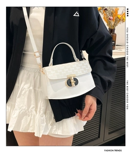 Chic white crossbody bag with gold-tone twist lock shown on a model for daily styling