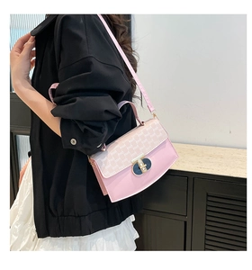 Detail of pink crossbody bag featuring monogram flap and gold rotary lock for women