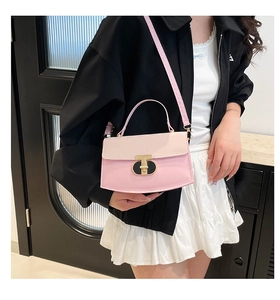 Close-up of pink patchwork crossbody bag with metallic T-shaped lock and leather strap