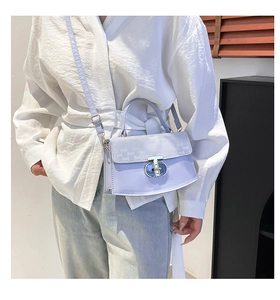Detail of light purple quilted handbag with chain strap and silver twist lock closure