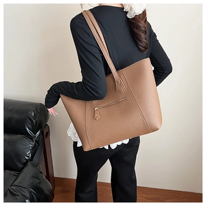 Detailed back view of brown lychee-textured tote bag showing functional zipper pocket