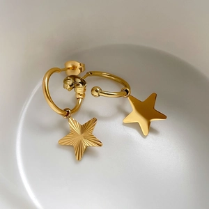 Elegant gold hoop earrings with textured star pendants for women in minimalist style