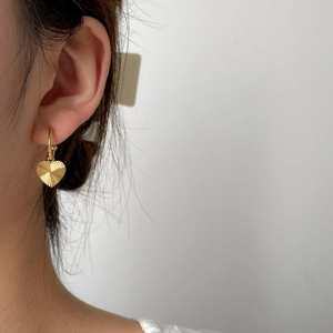 Golden heart drop earrings with radial sunburst texture and elegant metallic finish