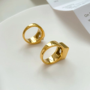 Macro detail of 18k gold plated titanium rings with large square and round cubic zirconia stones