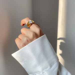 Titanium steel ring with 18k gold plating and large round zircon on a wide gold band
